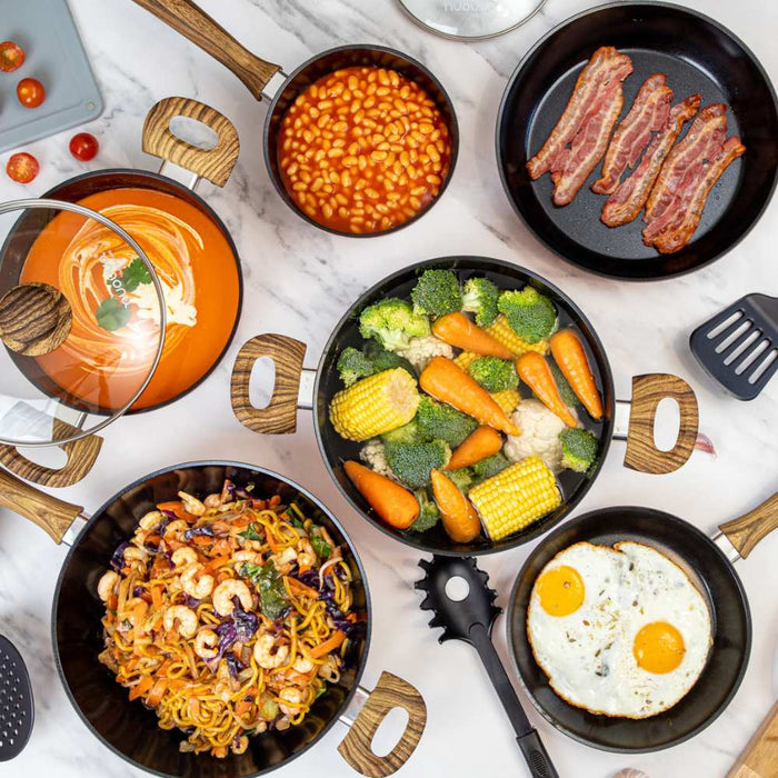 Image displaying nuovva cookware set containing pots, pans & utensils in use.