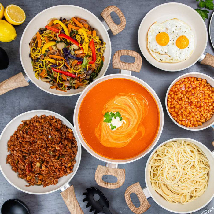 Nuovva 15 piece cookware set with pots, pans and utensils being used for easy cooking. Shop kitchenware.