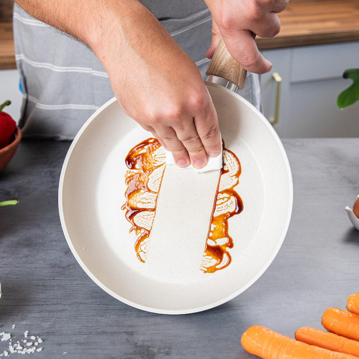 Nuovva 15 piece cream granite cookware set including easy to clean frying pan for efficient home use.