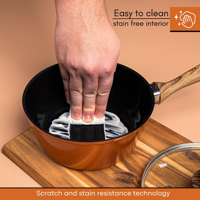Nuovva easy to clean stain-free interior copper saucepan with wooden handle and glass lids. Cookware with scratch and stain resistant technology.