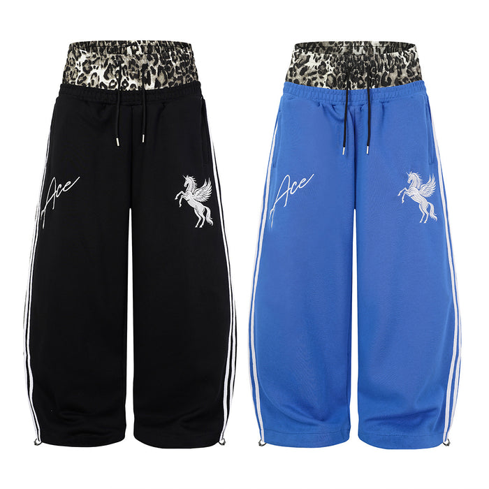 Black and blue wide-leg sweatpants shown from the front with leopard-print waistbands and white side stripes