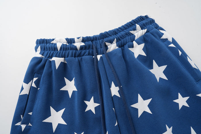 Close-up of blue sweatpants waist and side pocket with white star print