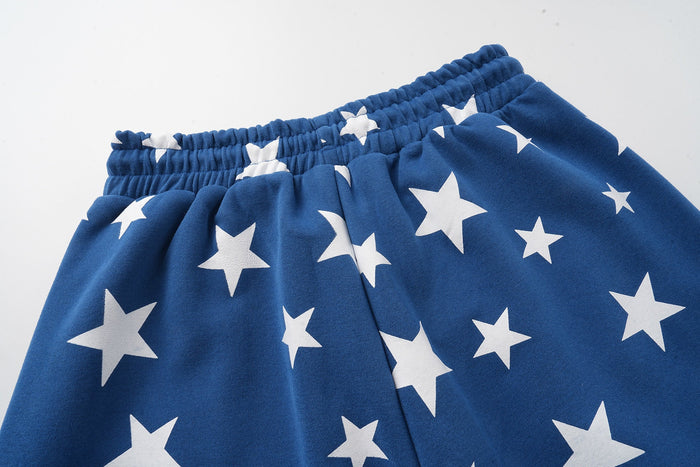 Close-up of blue sweatpants waistband with white star print