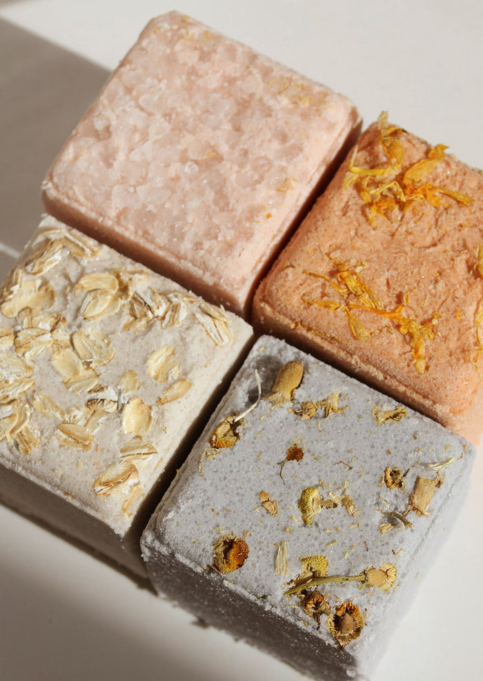 Four bath cubes in assorted colors.