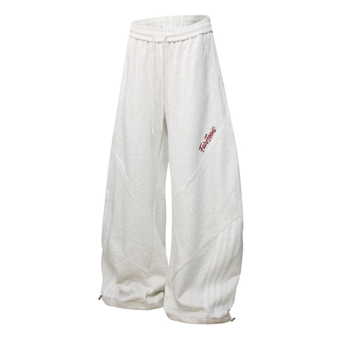 Light heather gray sweatpants with wide legs, curved seams, and small red side script logo