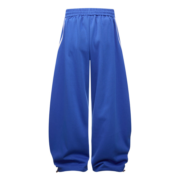 Back view of royal blue wide leg track pants with elastic waistband and plain legs