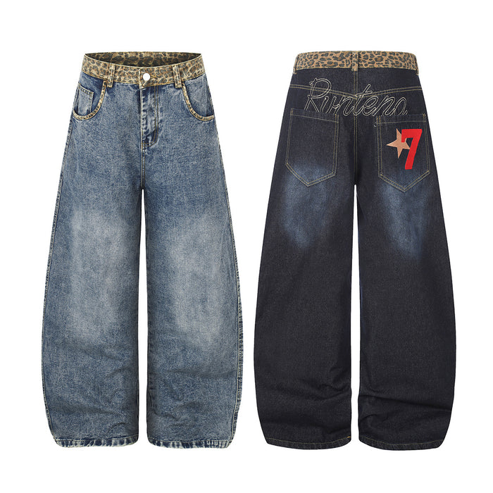 Baggy wide-leg jeans with leopard-print waistband shown front and back, featuring embroidered script and star graphic on dark