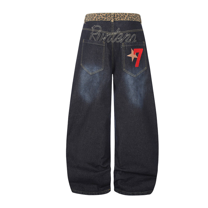 Back view of dark indigo wide-leg jeans with leopard-print waistband, stitched pockets, and red star graphic