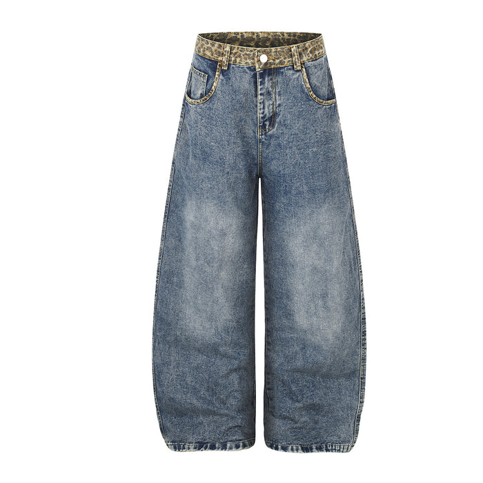 Front view of light blue wide-leg jeans with leopard-print waistband, curved front pockets, and button fly
