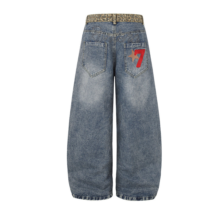 Back view of light blue jeans with leopard-print waistband, stitched pockets, and red star graphic