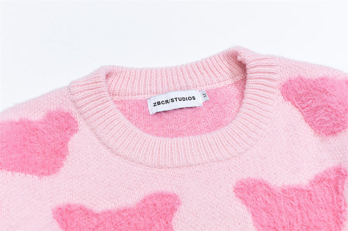 Close-up of the pink sweater neckline showing ribbed trim, fuzzy knit texture, and sewn-in label