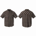 Front and back view of a distressed black plaid short sleeve shirt with frayed hem and metal stud chest detailing