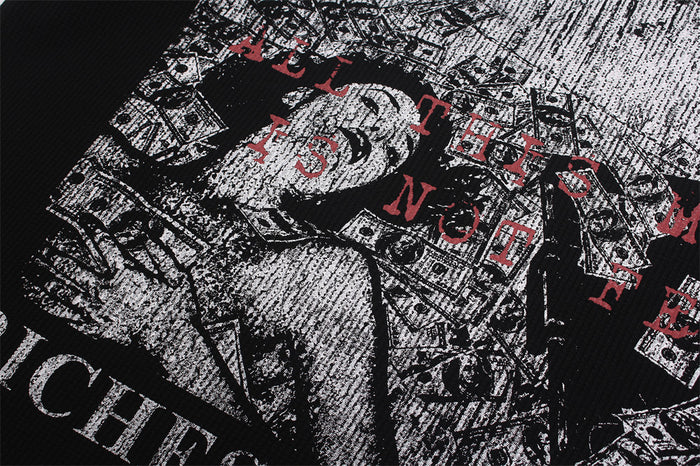 Shirt graphic detail showing distressed dollar imagery, white artwork, and red lettering on black fabric