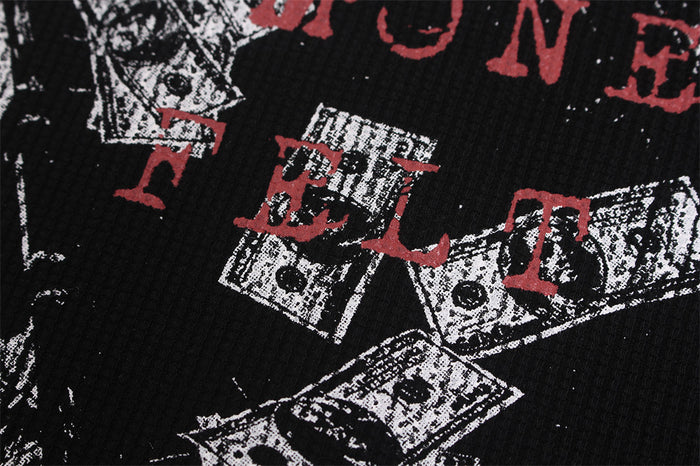 Close-up of red lettering printed over overlapping black-and-white dollar bill illustrations