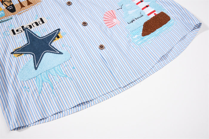 Lower front detail of the striped shirt showing embroidered starfish, beach graphics, buttons, and hem