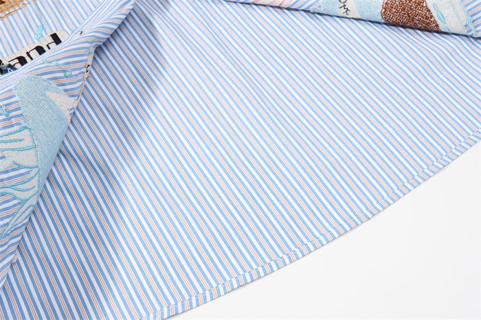 Inside view of the shirt showing the blue-and-white striped fabric, inner seams, and embroidered front panel