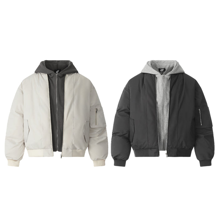 Two padded bomber jackets in cream and black, shown front-facing with contrasting hood layers and ribbed trims