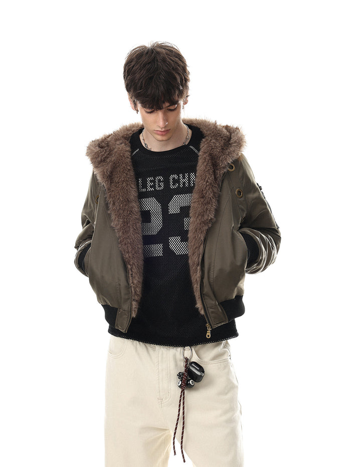 Model wearing an olive green hooded bomber jacket with a brown faux fur collar, black ribbed trim and front pockets