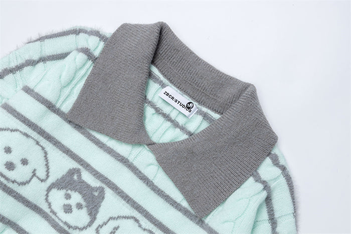 Close-up of the mint sweater showing its textured gray polo collar and cartoon dog knit pattern