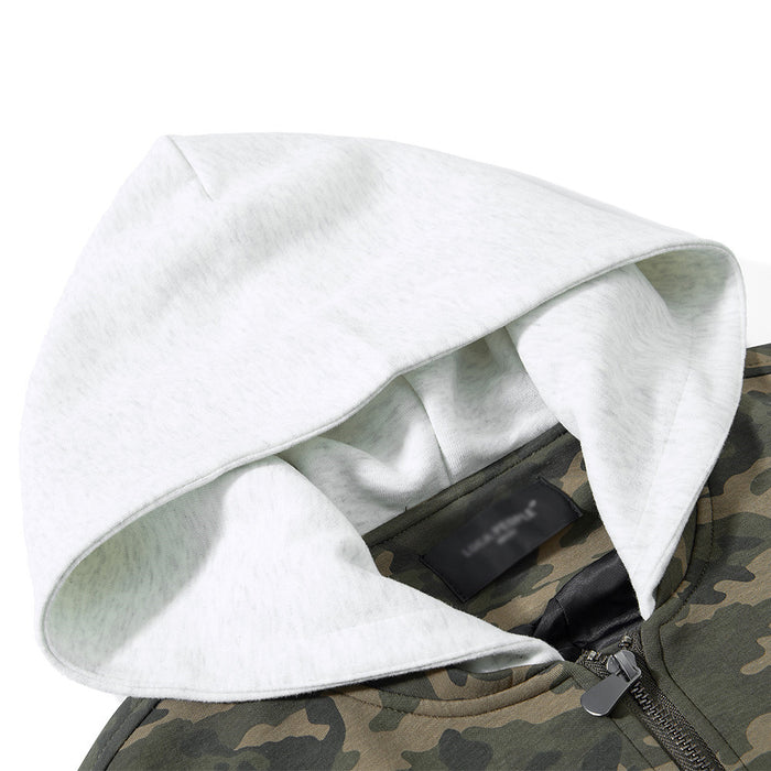 Close-up of the light contrasting hood, visible inner lining, neck seam, and camouflage jacket collar