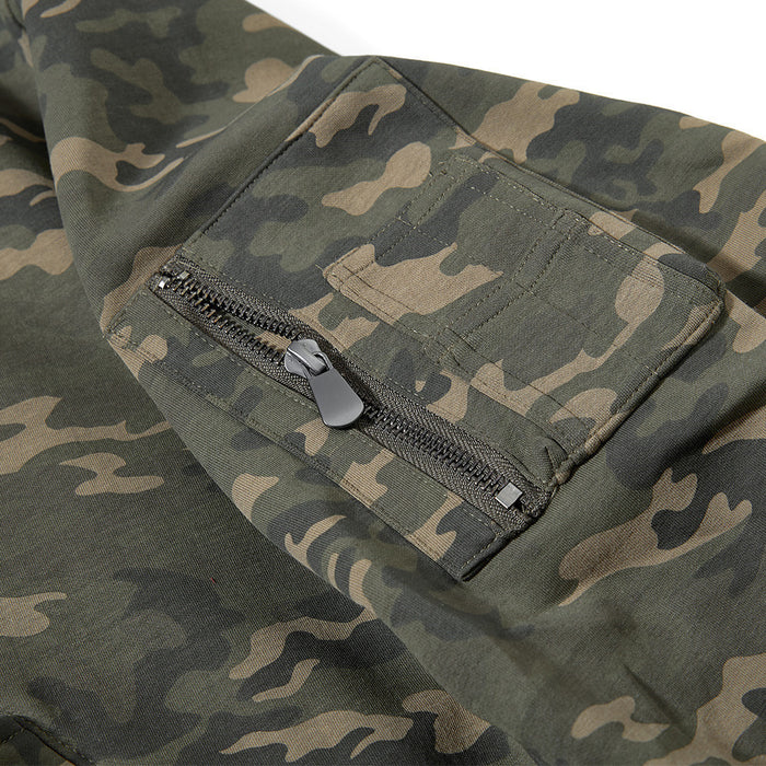 Close-up of a zippered sleeve pocket on the green and brown camouflage jacket