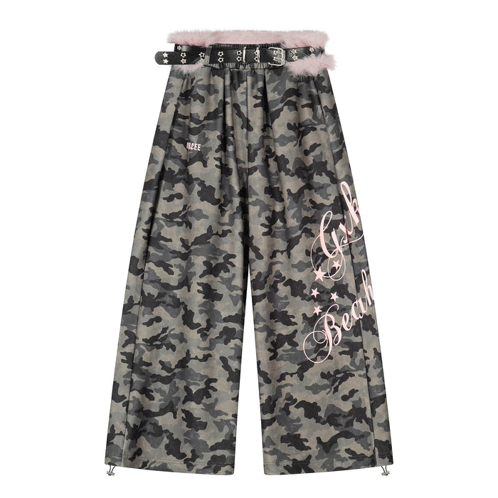 Front view of wide-leg camo pants with pink faux fur waistband and studded black belt