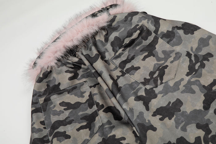 Close-up of camo pants back pockets beneath pink faux fur waistband trim