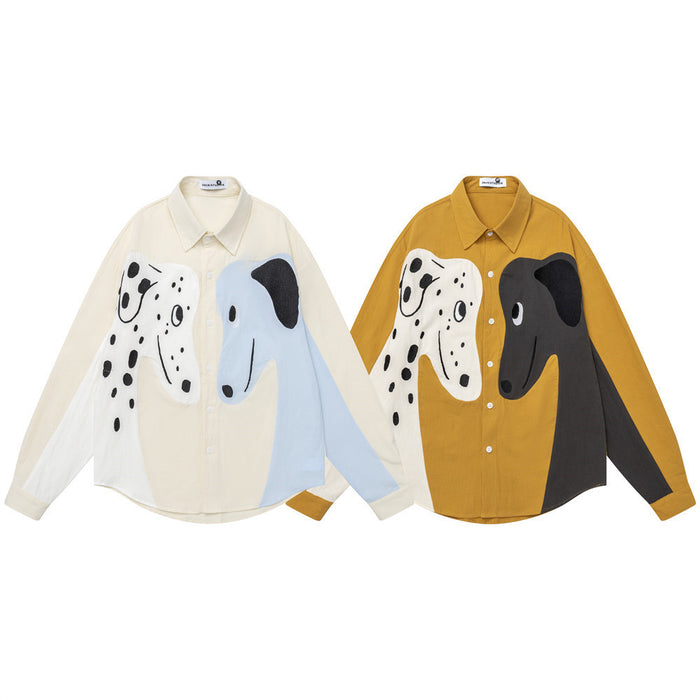 Two front-view colorblock button-down shirts, one cream and light blue and one ochre and charcoal, with dog graphics