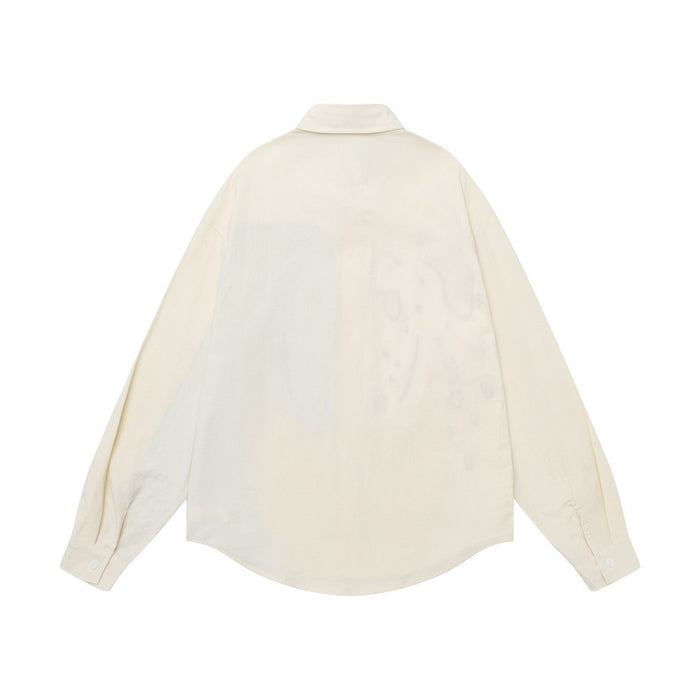Back view of the cream button-down shirt showing its plain back, collar, long sleeves, and curved hem