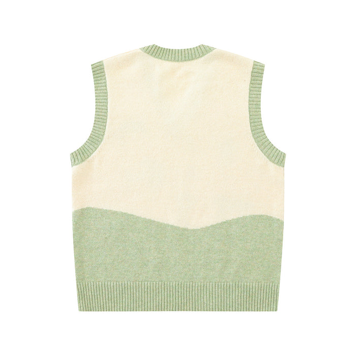Back view of the cream and sage green knit sweater vest with a wave-shaped colorblock hem