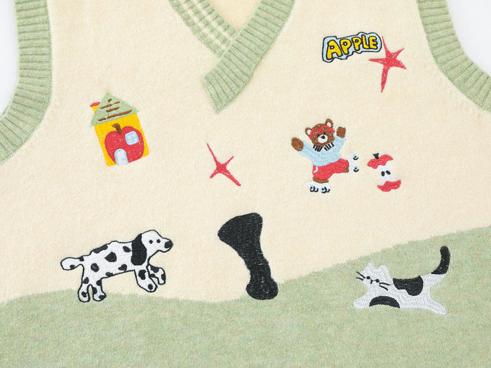 Close-up of embroidered cartoon motifs including a cow, black bone, cat, snack carton, and small figure