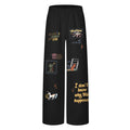 Front view of black wide-leg sweatpants featuring colorful cartoon-style graphics and text prints