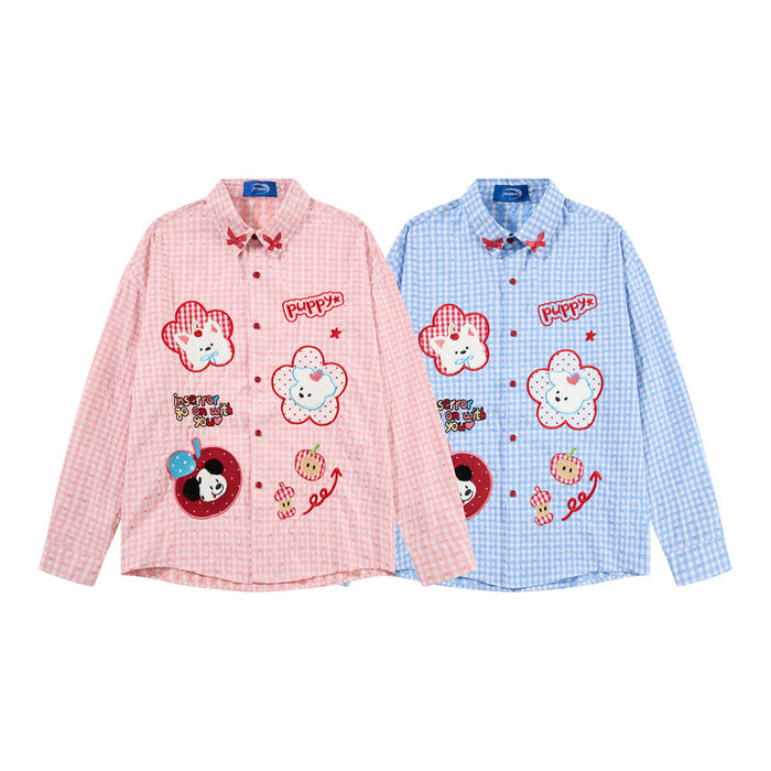 Front view of pink and blue gingham shirts with long sleeves, red bow collars and colorful cartoon patches
