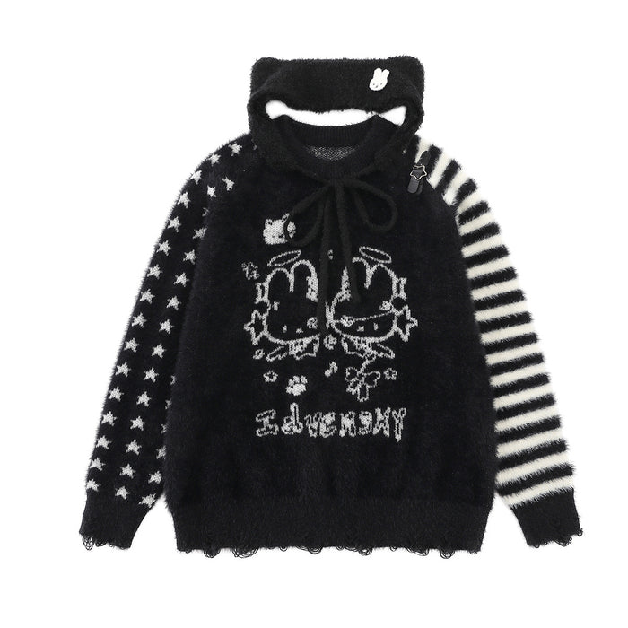 Black fuzzy knit sweater with bunny graphic, mixed star-and-stripe sleeves, and a tied black collar
