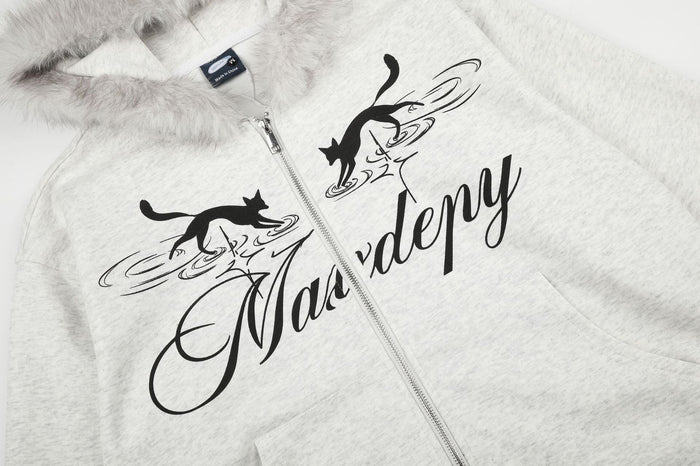 Front detail of light gray hoodie showing twin black cat graphics, script lettering, zipper, and faux fur hood trim