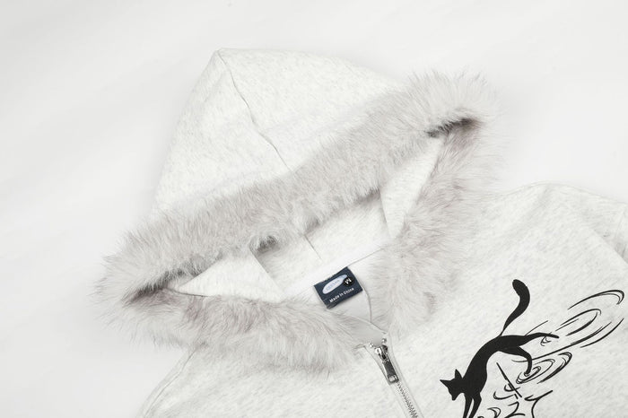 Close-up of the hood with soft faux fur trim, inner label, zipper, and partial black cat graphic