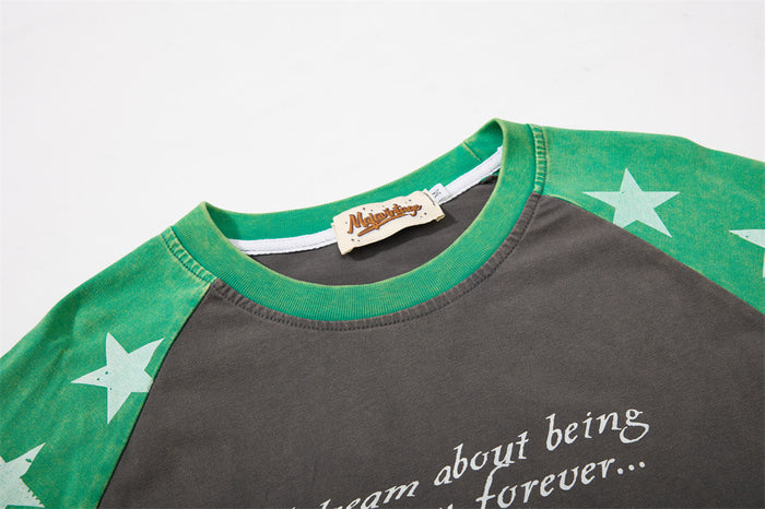 Close-up of green ribbed crew neck and star-print raglan shoulder seam