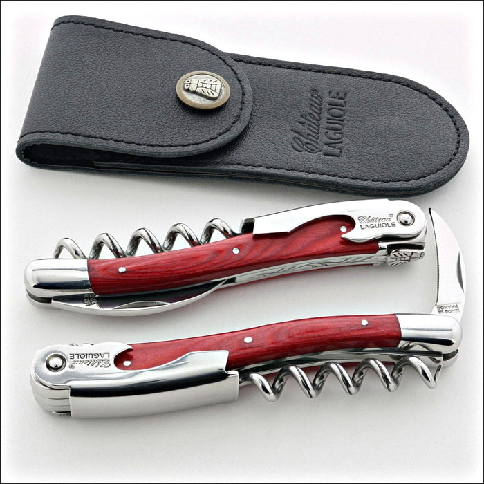 Chateau Laguiole Classic Red Stamina Corkscrew, top-down view of two red wood and stainless steel corkscrews with black leather pouch. Handcrafted details, 100% Made in France.