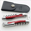 Chateau Laguiole Classic Red Stamina Corkscrew, top-down view of two red wood and stainless steel corkscrews with black leather pouch. Handcrafted details, 100% Made in France.