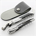 Chateau Laguiole Eric Beaumard Corkscrew, top-down view of two corkscrews and a grey leather sheath. Handcrafted details, 100% Made in France.
