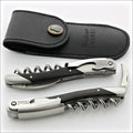 Chateau Laguiole Grand Cru Ebony Corkscrew, top-down view of two corkscrews and a black leather pouch. Handcrafted details, 100% Made in France.