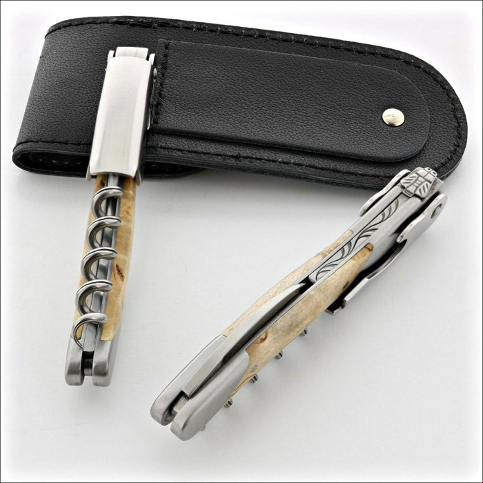 Chateau Laguiole Grand Cru Karelian Birch corkscrews, top-down view of two with a black leather case. Handcrafted details, 100% Made in France.