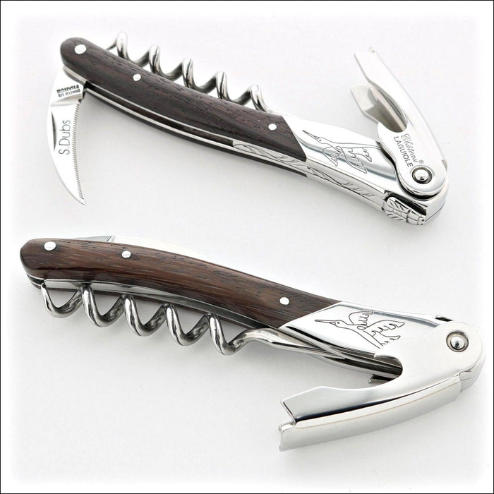 Chateau Laguiole Serge Dubs corkscrew, top-down view. Dark wood handle, polished stainless steel, crane design. Handcrafted details, 100% Made in France.