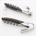 Chateau Laguiole Serge Dubs corkscrew, top-down view. Dark wood handle, polished stainless steel, crane design. Handcrafted details, 100% Made in France.