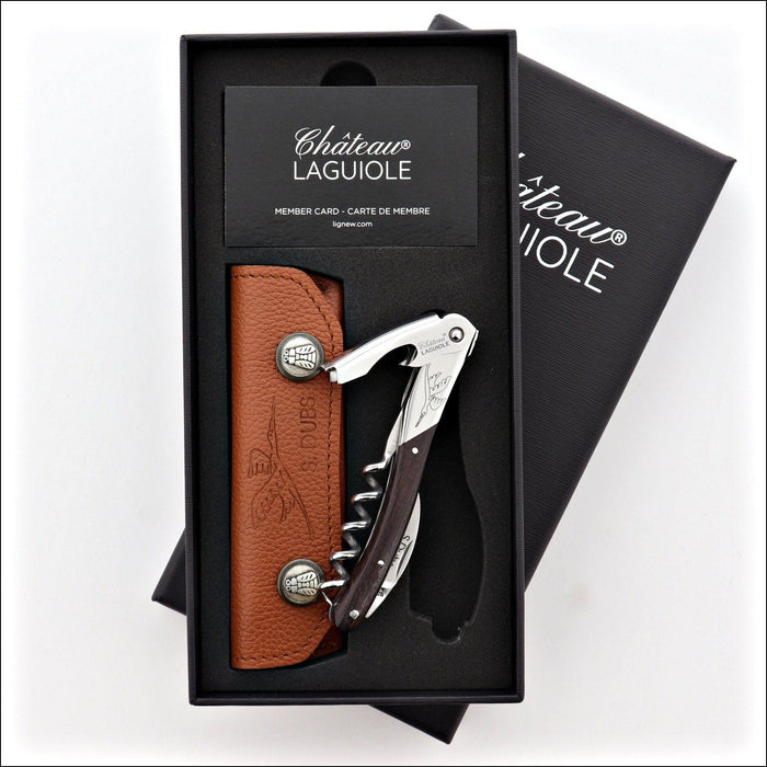 Chateau Laguiole Serge Dubs corkscrew set, top-down view. Dark wood handle, silver accents, brown leather pouch. Handcrafted details, 100% Made in France.