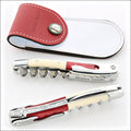 Chateau Laguiole Shinya Tasaki corkscrew, top-down view. Red wood, ivory handle, polished steel, and matching red leather sheath. Handcrafted details, 100% Made in France.