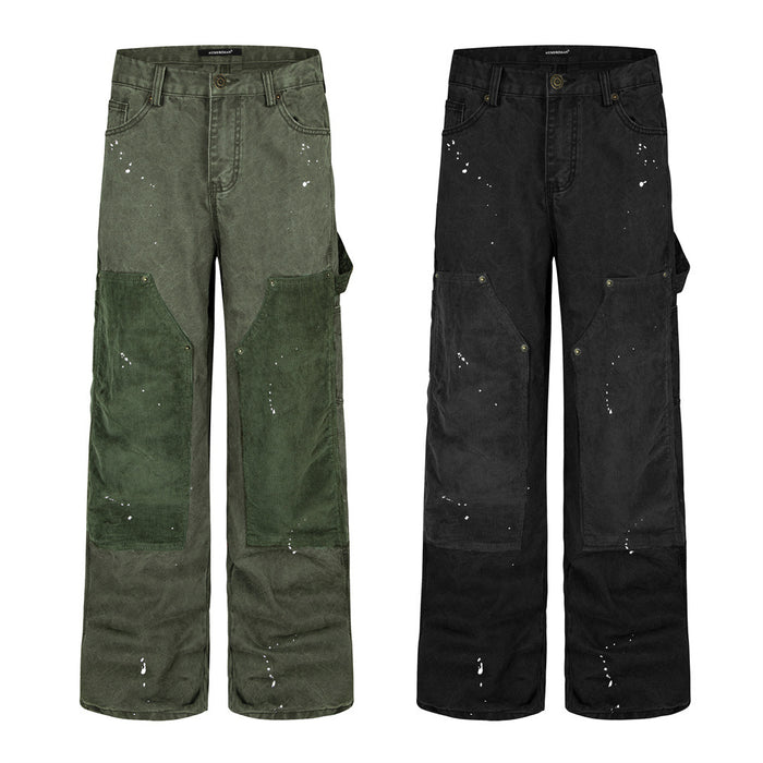 Men's wide-leg corduroy patchwork carpenter pants with white paint splatter in washed black and moss green