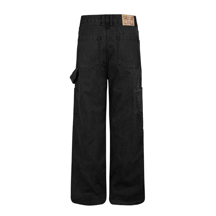Back view of black wide-leg carpenter pants with two patch pockets, side utility pockets, and a waistband label