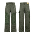 Olive green carpenter pants shown front and back with darker corduroy knee patches, utility pockets, and white paint splatters