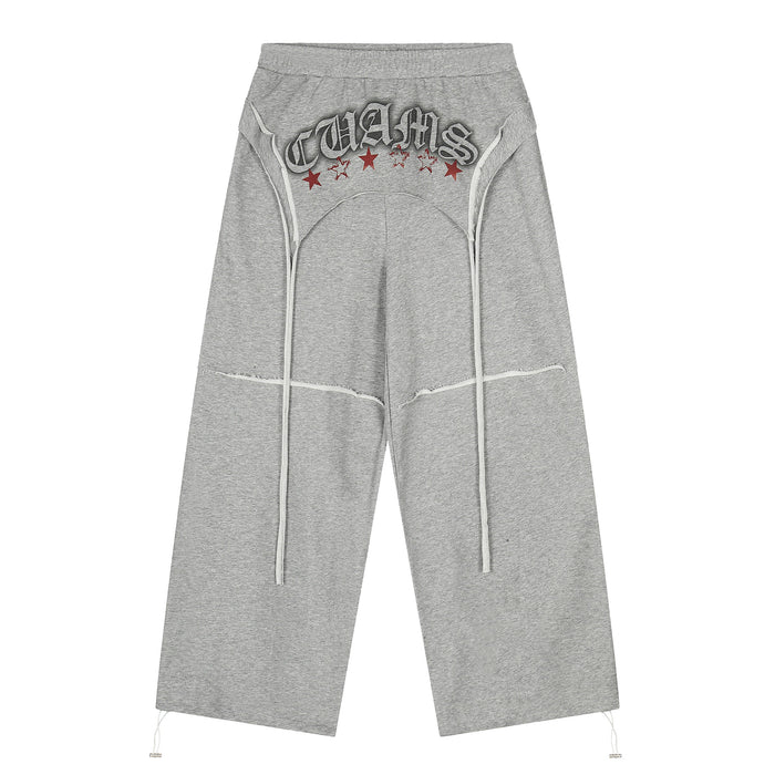 Gray wide-leg sweatpants with graphic text, red stars, and long drawstrings, front view